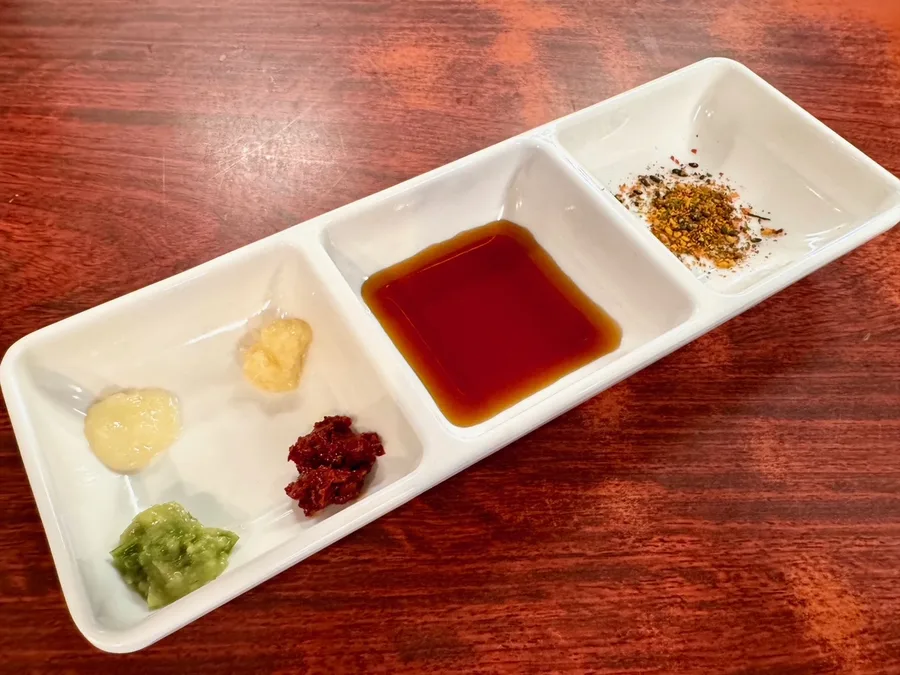 仕切りのある白い皿に入れた、薬味とダシ醤油